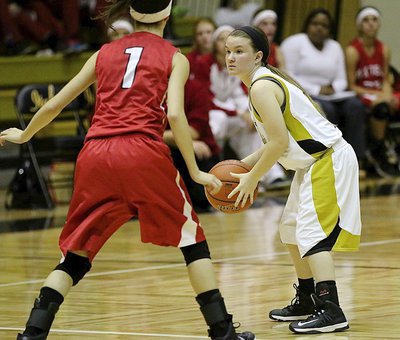 Image: Lady Gladiator point guard Tara Wallis(5) looks for a teammate open in the paint.