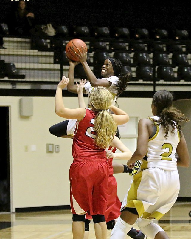 Image: Lady Gladiator senior Kortnei Johnson(3) steals the ball at one end of the floor and then scores at the other end before fans can turn their heads around. She be fast!