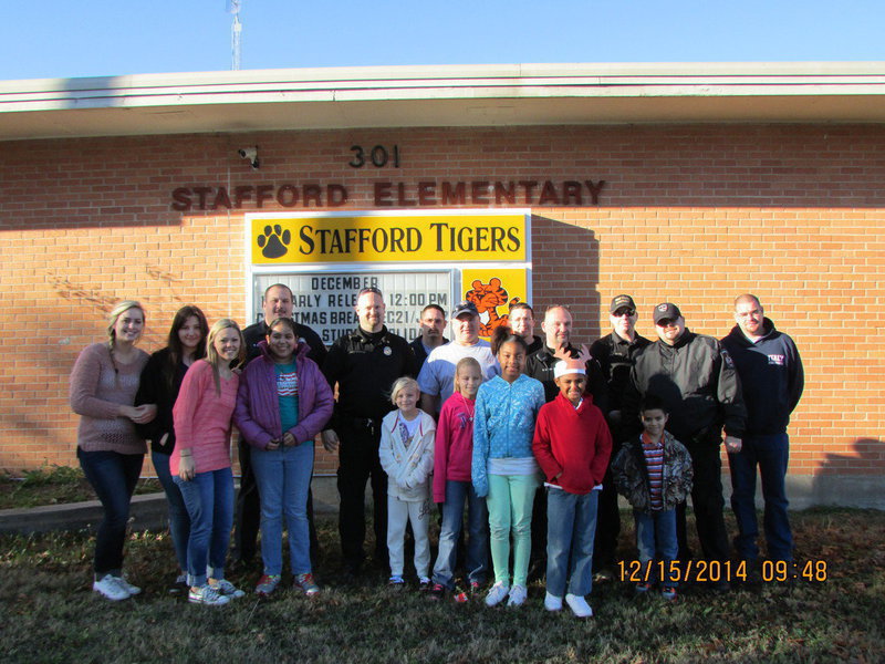 Image: Front row: Bailey Eubank, Oralia, Taylor, Kaylee, Shamiyah, Isaac, JR
    Back Row: Madison Washington, Alexis Sampley, Officer Elliott, Chief Martin, Firefighter Kimmons, Capt. Cate, Officer Click, Officer Saxon, Sgt Pitts, Officer Cherry, Lt B. Chambers