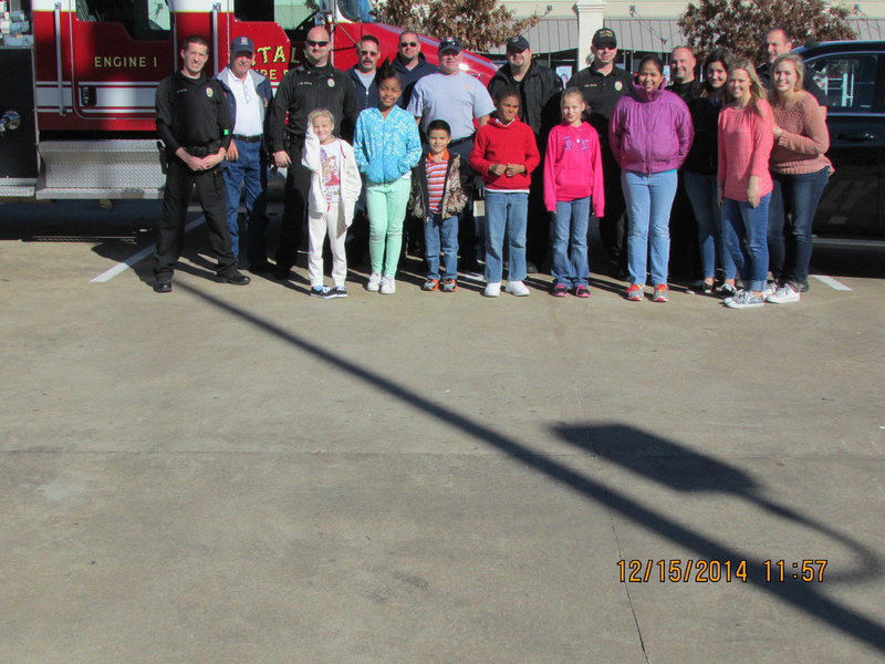 Image: Front row: Taylor, Shamiyah, JR, Isaac, Kaylee, Oralia, Bailey Eubank and Madison Washington. 
    Back Row: Officer Click, Chief Chambers, Chief Martin, firefighter Kimmons, Lt B. Chambers, Capt. Cate, Officer Cherry, Sgt Pitts, Officer Saxon, Alexis Sampley, Officer Elliott