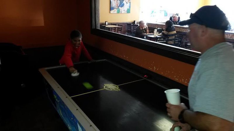 Image: Isaac and Capt Cate playing air hockey