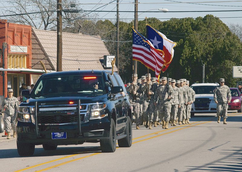 Image: The Italy Police Department, with police chief Shawn Martin at the wheel, lead the annual Christmas parade thru downtown with members of the National Guard close behind.