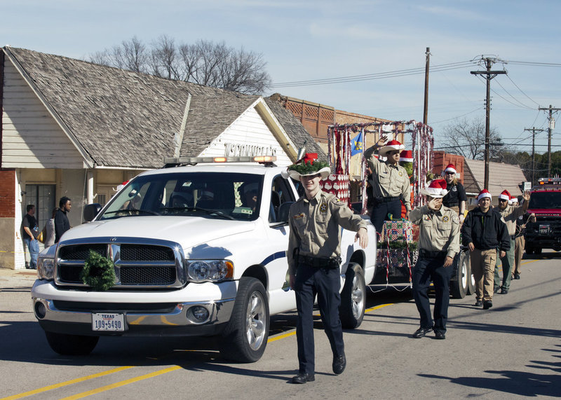 Image: Hunter Ballard and his fellow Boy Scouts join in on the Christmas parade fun in downtown Italy.