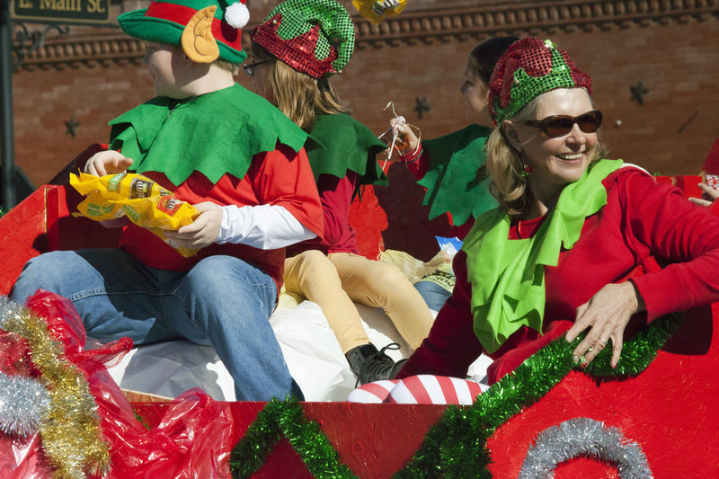 Image: Lead elf Mrs. Jeanette Janek and her team of elves (Stafford Elementary Student Council) deliver candy to parade watchers via Santa’s sleigh.