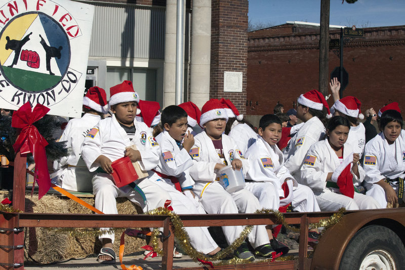 Image: Hillsboro Unified Tae Kwon Do students  focus on delivering candy to parade watchers in downtown Italy.
