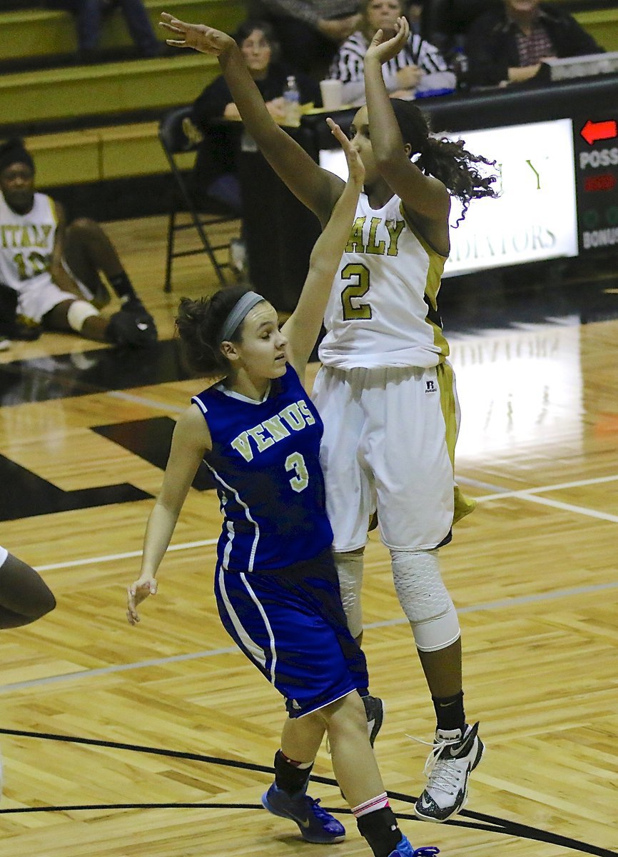 Image: Emmy Cunningham(2) drops in a jumper with a hand in her face.