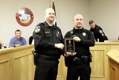 Image: Chief Shawn Miller presents the Rookie of the Year award to Officer Guy Saxon.