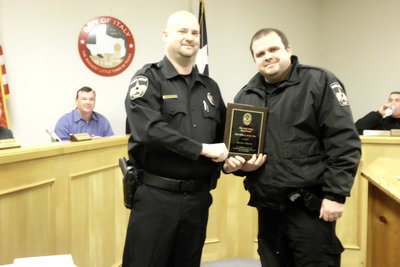 Image: Chief Shawn Miller  presents the Officer of the Year award to Officer Jason Cherry.
