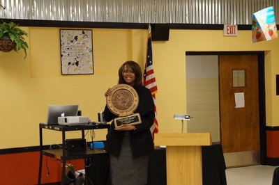 Image: Mrs. Thomas holds up the award for the Stafford Elementary.