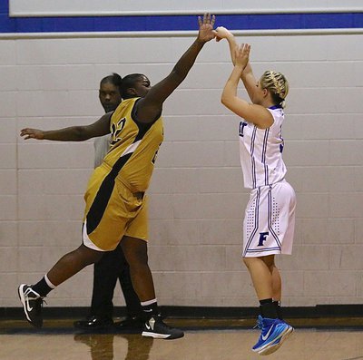 Image: Lady Gladiator Taleyia Wilson(22) closes out on a Frost shooter to keep the Lady Polar Bears cold from the arc.