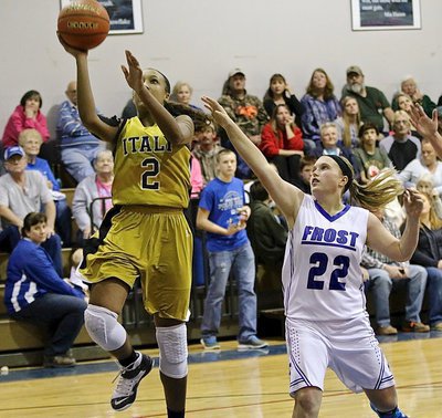 Image: Lady Gladiator Emmy Cunningham(2) scores a layup at will despite efforts by Frost to slow her down.