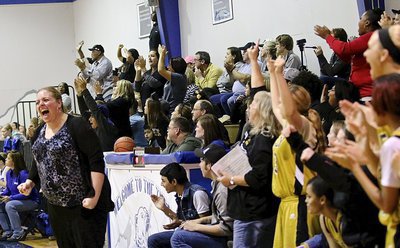 Image: Lady Gladiator Head Coach Melissa Fullmer leads the cheers after Italy’s 57-44 district win over Frost.