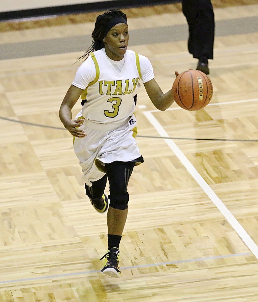 Image: Kortnei Johnson(3) hurries the ball up the court as Italy transitions into attack mode.