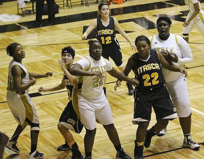Image: K’Breona Davis(10), Taleyia Wilson(22) and Cory Chance(33) react to a shot attempt from the corner.