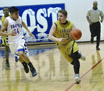Image: Senior John Escamilla(13) hurries the ball up the floor for the Gladiators.
