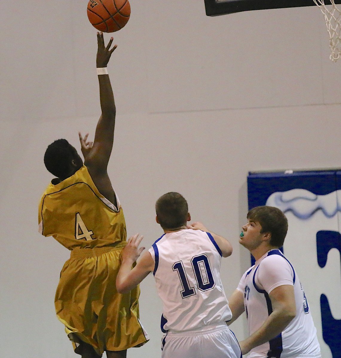 Image: JV Gladiator Anthony Lusk(4) gets the jump on Frost defenders to get a shot up.