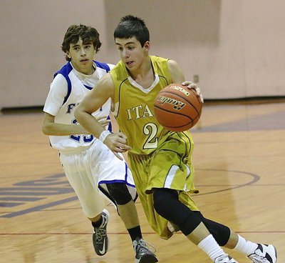 Image: Italy’s Gary Escamilla(2) surges past a Frost defender on his way to the hoop.