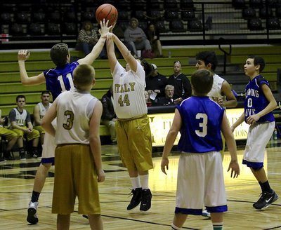 Image: Italy 8th grader Mikey South(44) tries to shoot over a Lion defender.
