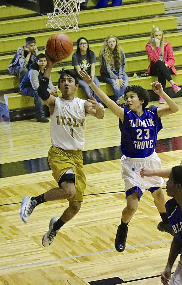 Image: Italy 8th grader Marcos Duarte(1) styles in for layup attempt.