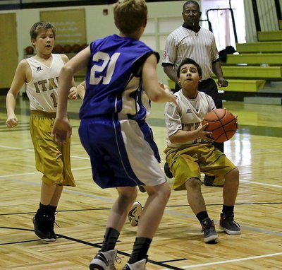 Image: Italy 7th grader and point guard Jesus Enriquez(13) stops and pulls up for a shot attempt with teammate Tanner Chambers(14) filling the lane.