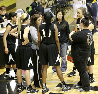 Image: JV Lady Gladiator head coach Tina Richards (in the grey) and assistant coach Nicole Tindol talk up their squad during a timeout.
