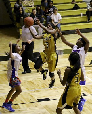 Image: Kortnei Johnson(3) continues her relentless attack thru a wave of Gators.