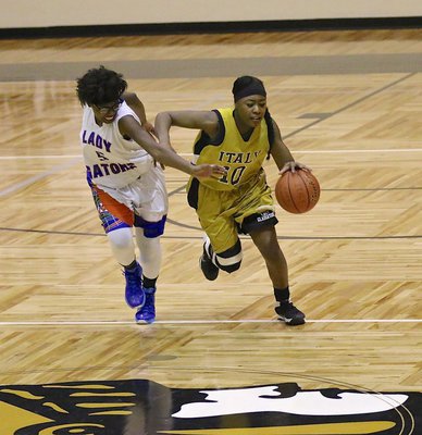 Image: Senior Lady Gladiator K’Breona Davis(10) steals the ball away from a Lady Gator. Davis does whatever it takes to keep Italy going forward.