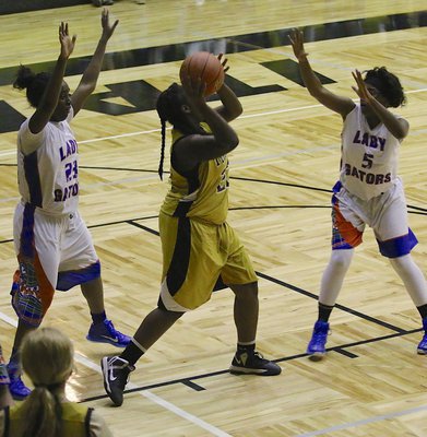 Image: Lady Gladiator Taleyia Wilson(22) secures a rebound and then resets the offense.