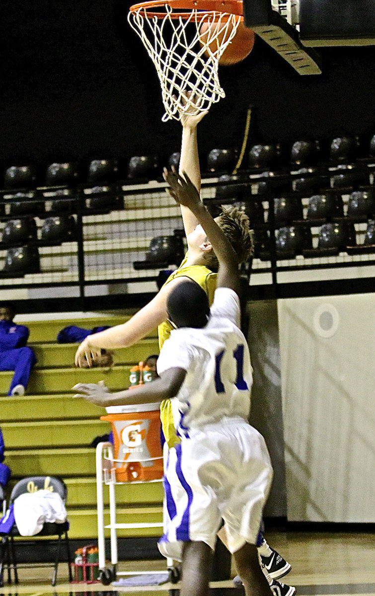 Image: JV Gladiator James Walton(11) executes a behind the back lay-in against Gateway’s defense.