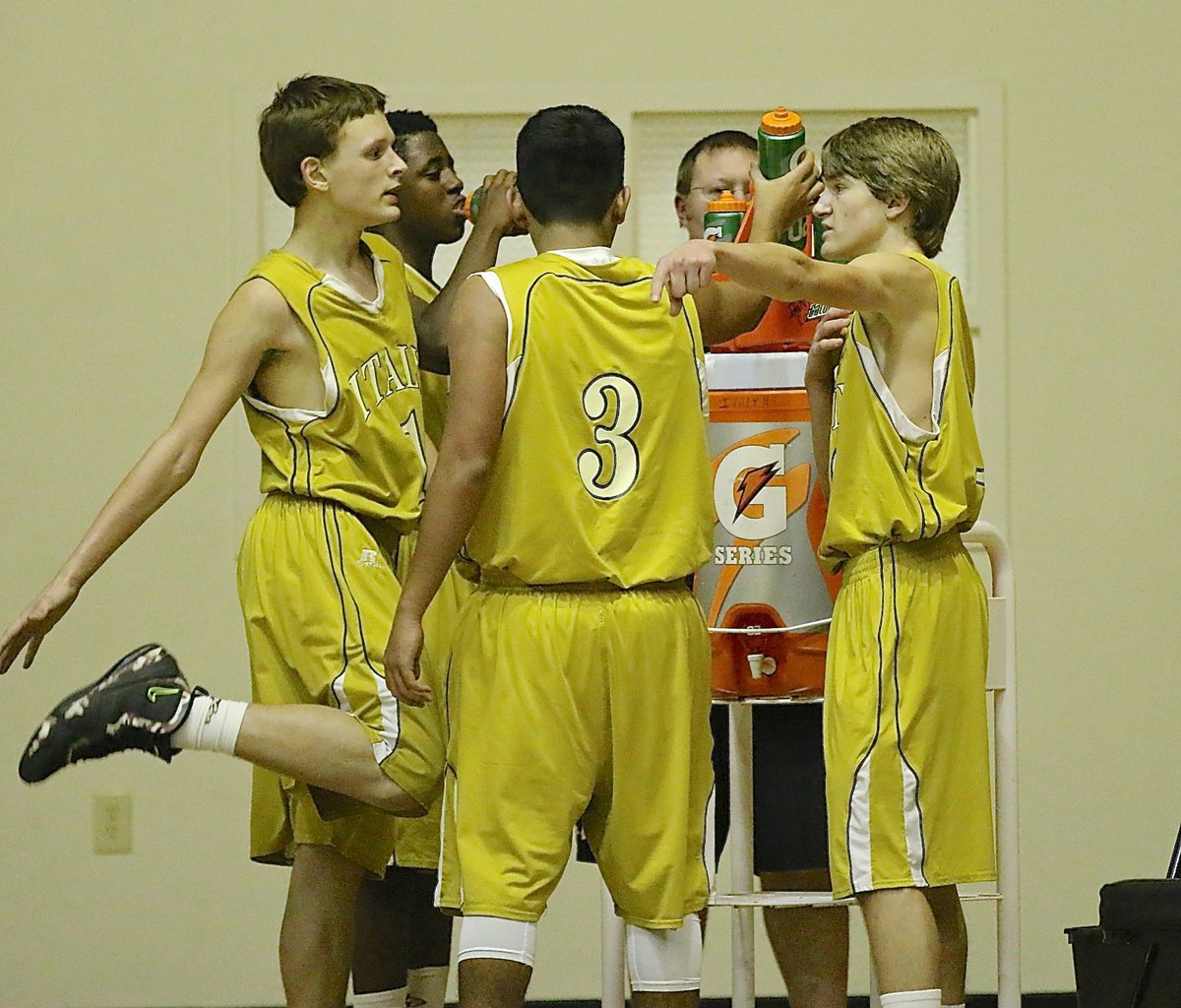 Image: Office talk around the water cooler. Joshua Cryer(1), Anthony Lusk(4), Jorge Galvan(3) and Garret Janek(12) talk shop during a break.