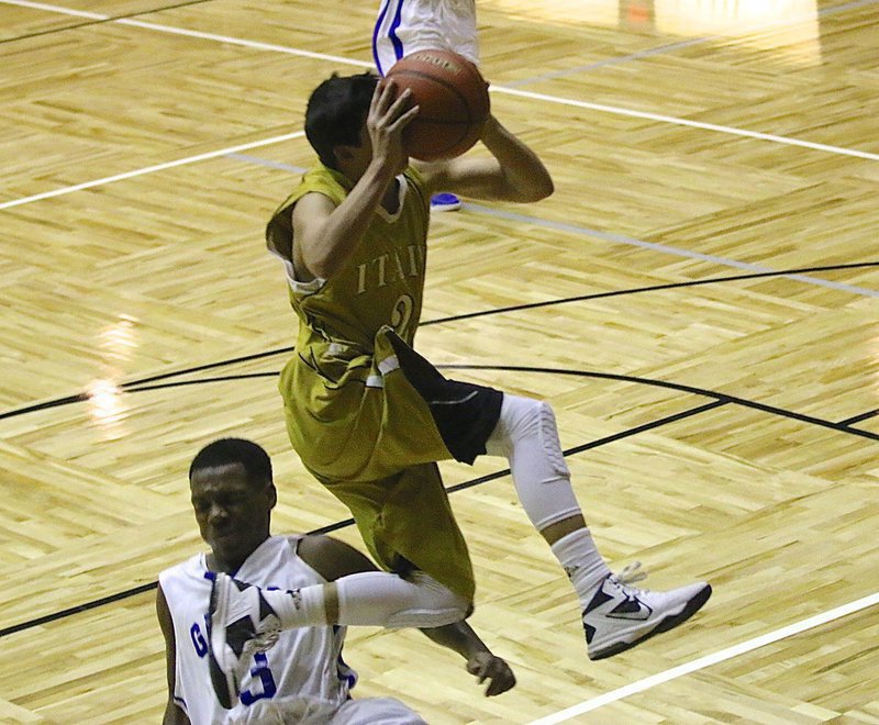 Image: JV Gladiator Gary Escamilla(2) gets tripped up by a Gator defender. Escamilla was fine and went to the free-throw line after drawing the foul.