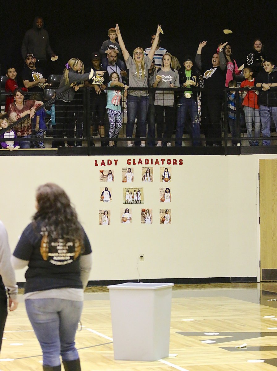 Image: Lady Gladiator Softball senior Madison Washington celebrates after her tortilla swished into the waiting trash can during intermission. In fact, four tortillas made it in for a new record. Madison donated her winnings back to the team.