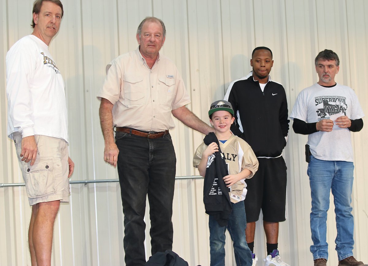 Image: IYAA C-team Quarterback Gared Wood(4) is presented his Superbowl Championship hoodie by City of Italy’s Mayor James Hobbs and IYAA President Charles Hyles. Pictured on the right are C-team coaches Andre Speed and Gary Wood who is also Gared’s father.