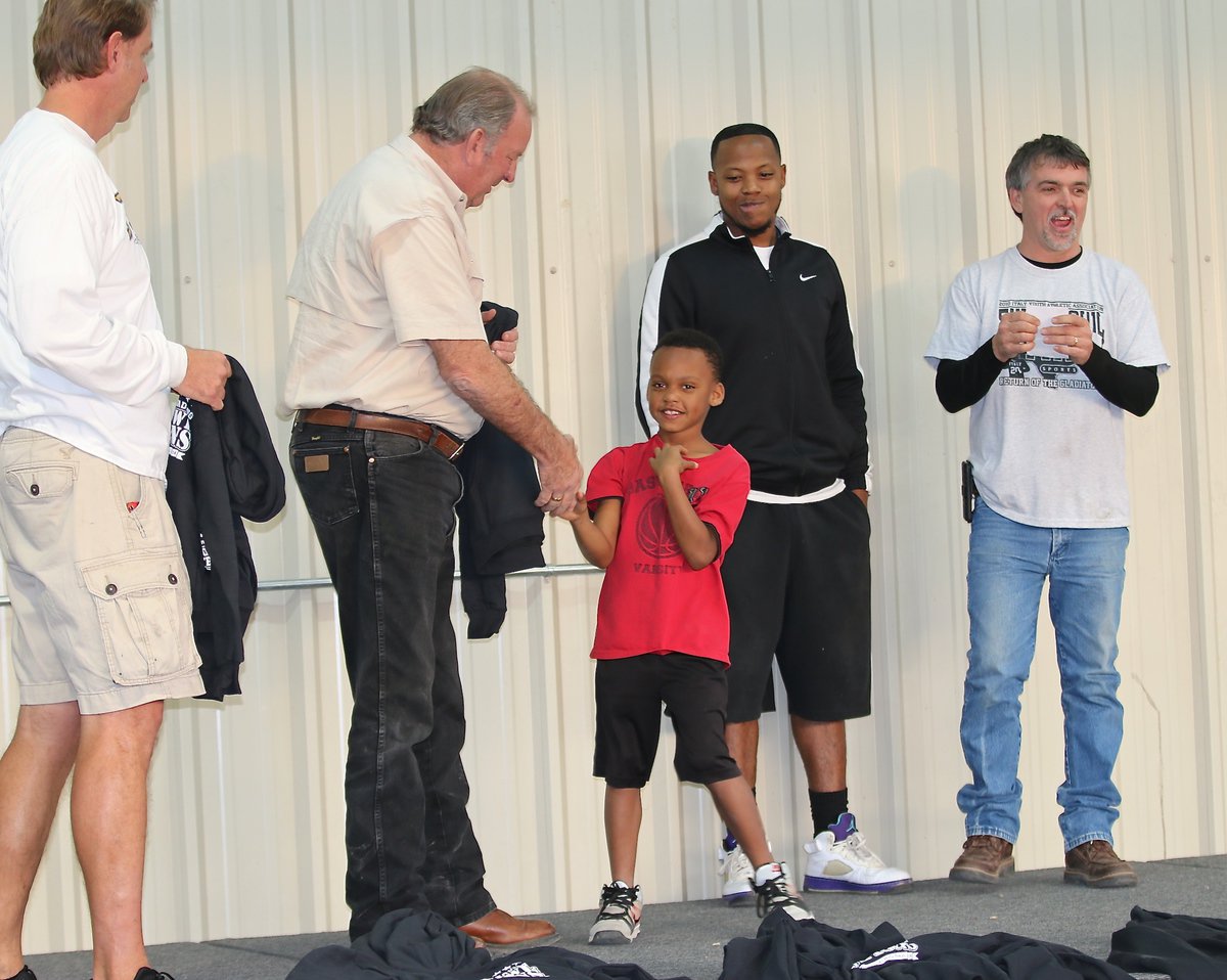 Image: IYAA C-team tailback Curtis Benson(1) shakes hands with Mayor James Hobbs before receiving his Superbowl Championship hoodie.