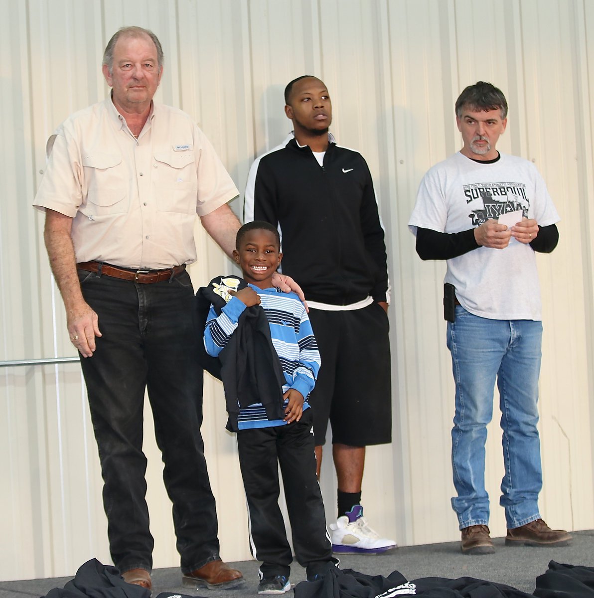 Image: IYAA C-team tight end Elijah Davis(18) is all smiles after being presented his Superbowl Championship hoodie from Mayor James Hobbs.