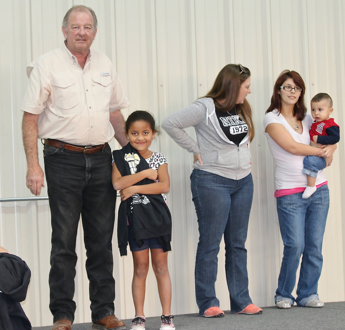 Image: City of Italy’s Mayor James Hobbs presents C-team cheerleader Mikyla Davis with her Superbowl Championship hoodie as cheer coaches Kia Hugghins and Lindy Wooldridge introduced their girls.