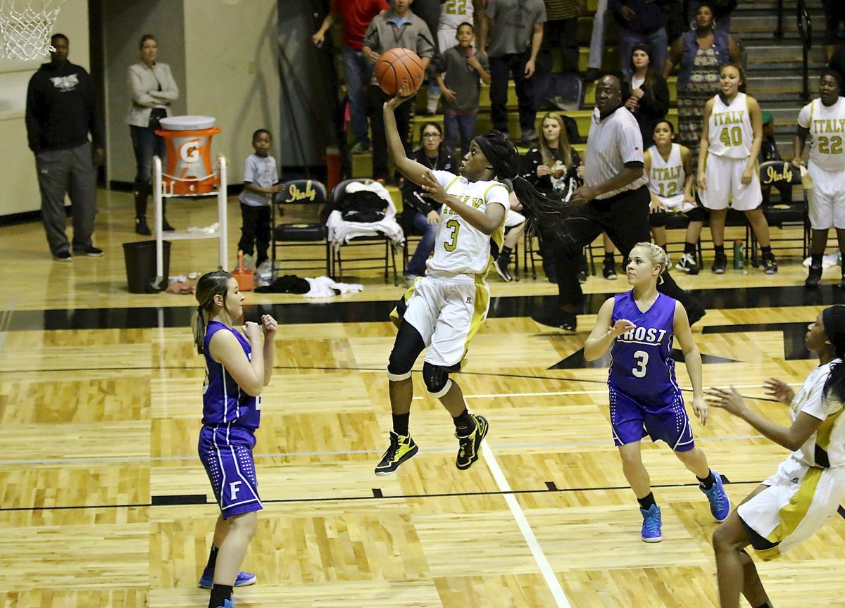 Image: Senior Lady Gladiator Kortnei Johnson(3) drives the length of the court in four seconds flat to put in the game-winning shot over the Frost Lady Polar Bears at home in Italy Coliseum. The ball circled the rim dramatically before falling thru to secure a 64-62 district win for the Lady Gladiators who need one more win over Dallas Gateway this coming Tuesday to become undefeated district champions. Johnson finished with 19-points.