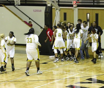 Image: The Lady Gladiators join Kortnei Johnson(3) at the opposite end to celebrate some more as Johnson was able to share the moment with her father, James Johnson (In the red shirt).