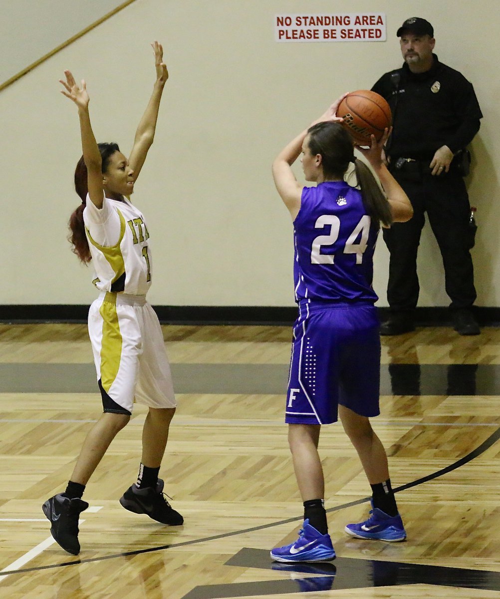 Image: Italy’s T’Keya Pace(1) guards Frost senior Jae Moore(24) on the wing. Moore is kin to former Gladiator head coach Kyle Holley who was in attendance for the high profile matchup.