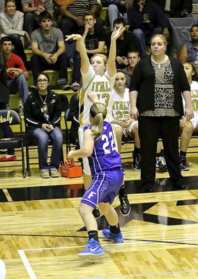 Image: Brycelen Richards(13) attempts a three-pointer with Lady Gladiator head coach Melissa Fullmer giving her the green light. Brycelen’s mother, Tina Richards, is an assistant coach on the team and Brycelen is following in the path of her older sisters, Meagan Richards and Alyssa Richards.
