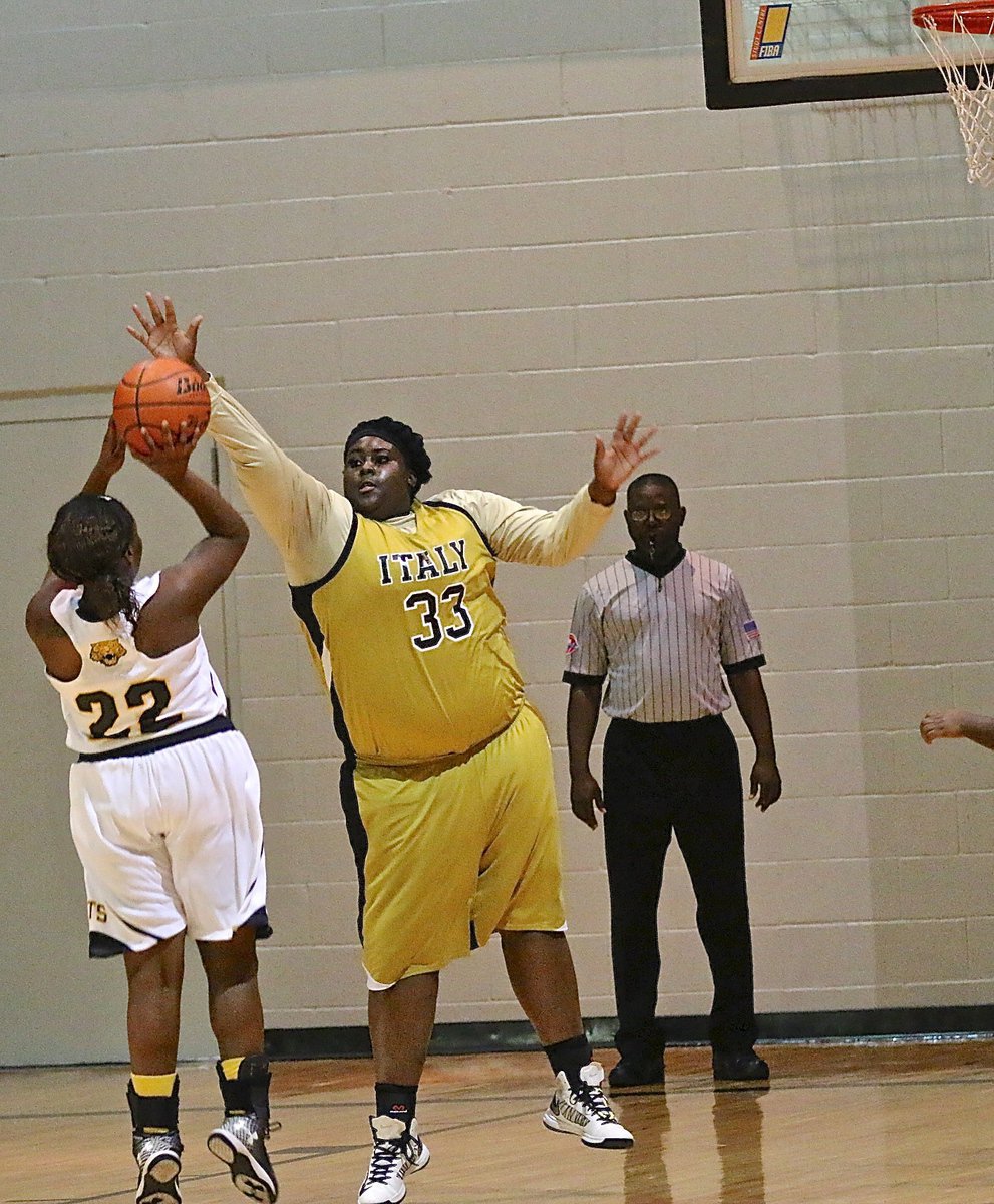 Image: Lady Gladiator Cory Chance(33) forces a tough shot attempt by Itasca.