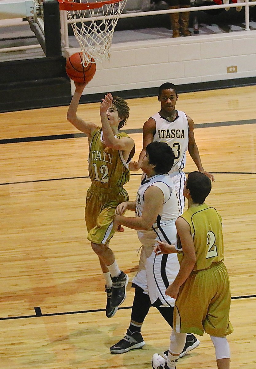 Image: JV Gladiator Garrett Janek(12) goes in for a layup.