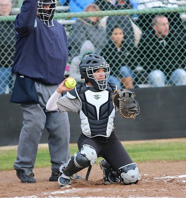 Image: Catcher April Lusk pulls in a strike for pitcher Jaclynn Lewis.