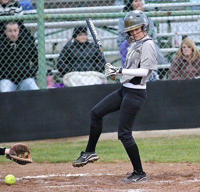 Image: Lady Gladiator Cassidy Childers(3) is clipped by a pitch into her legs and gets to take her base.