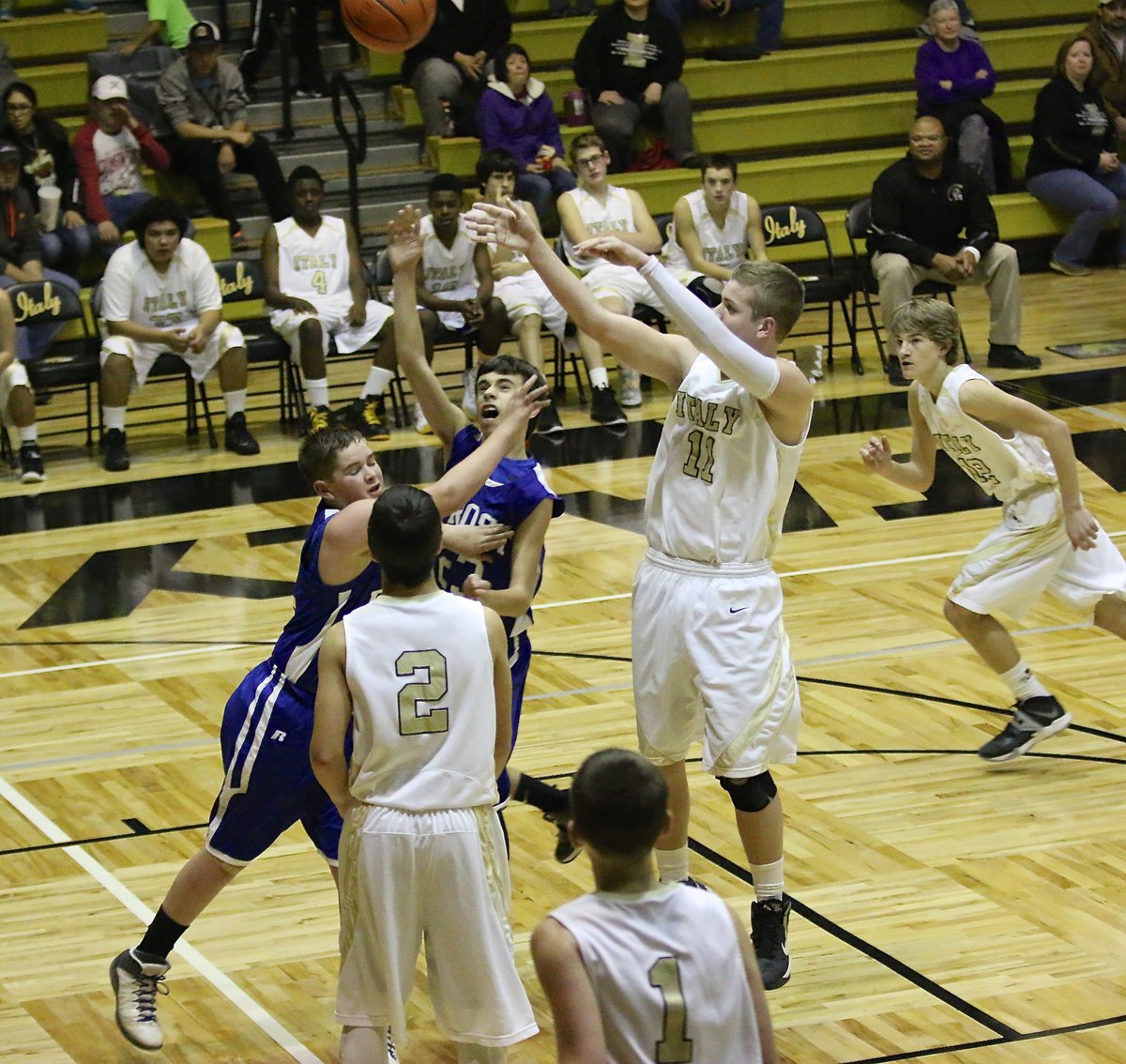 Image: James Walton(11) shoots from just below the elbow and over the heads of two Frost defenders.