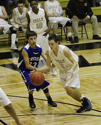 Image: JV Gladiator Dylan McCasland(5) dribbles past a Frost defender to get into the lane.