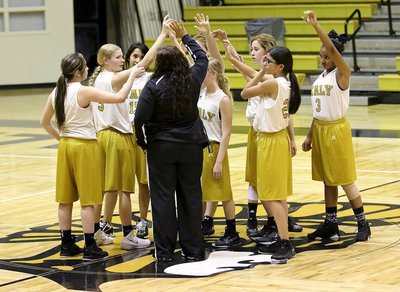 Image: The A-team Lady Gladiators have one last huddle to their 2015 season with head coach Tina Richards.