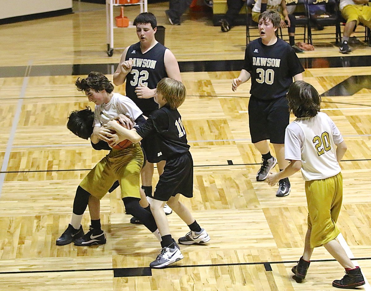 Image: Italy 8th grader Andrew Oldfield(2) fights over a rebound with teammate Joseph Vuittonet(20) coming in to help.