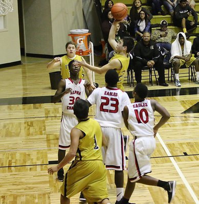 Image: Gladiator freshman Kyle Tindol(20) floats down the lane to put up a shot against Garland Alpha Charter.