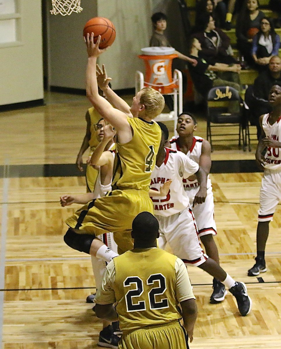 Image: Gladiator Cody Boyd(4) powers his way up to the hoop for a score.